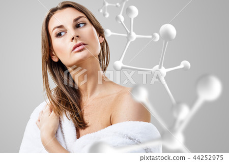 Beautiful woman in bathrobe near big white molecule chain. Beautiful woman in bathrobe near big white molecule chain. 44252975