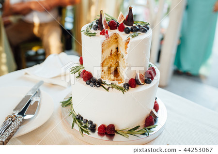 Beautiful cake covered with icing cream, summer berries on the top. Beautiful cake covered with icing cream, summer berries on the top. 44253067