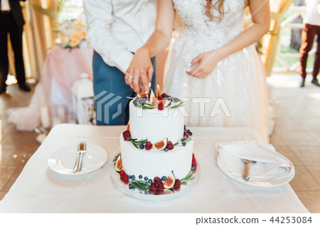 Beautiful cake covered with icing cream, summer berries on the top. Beautiful cake covered with icing cream, summer berries on the top. 44253084