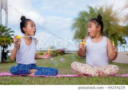 Happy time two girl sister play soap bubble  44254229