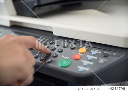 Office worker works with a multi-function device 44254796