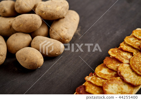 delicious golden potato pancakes on an old wooden black table 44255400