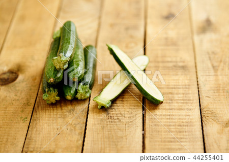 delicious and fresh baby zucchini on an old wooden table 44255401