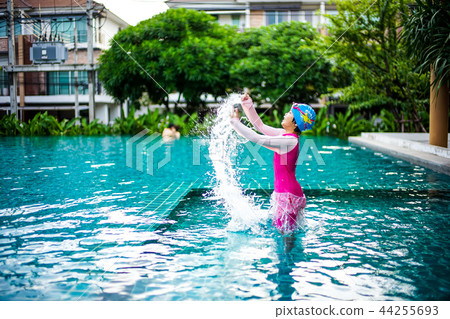 Asian little girl swiming happily in the pool Asian little girl swiming happily in the pool 44255693