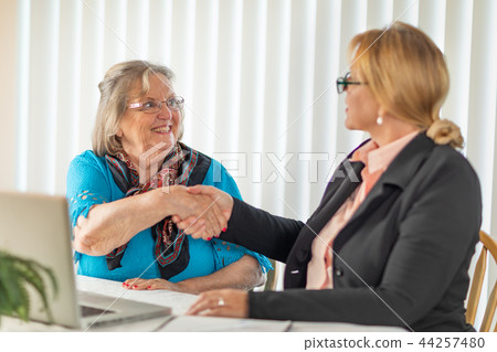 Businesswoman Helps Senior Lady on Laptop Computer 44257480