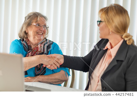 Businesswoman Helps Senior Lady on Laptop Computer 44257481