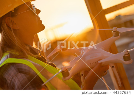 Female Drone Pilot Inspecting a Construction Site Female Drone Pilot Inspecting a Construction Site 44257684