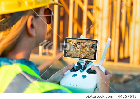 Female Drone Pilot Inspecting a Construction Site Female Drone Pilot Inspecting a Construction Site 44257685