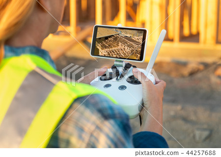 Female Drone Pilot Inspecting a Construction Site Female Drone Pilot Inspecting a Construction Site 44257688