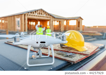 Construction Workers with Drone Inspect Job Site 44257929