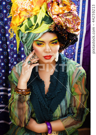 beauty bright woman with creative make up, many shawls on head l 44259213