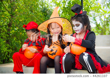 Girls in Halloween costume sitting on stair  Girls in Halloween costume sitting on stair  44261107