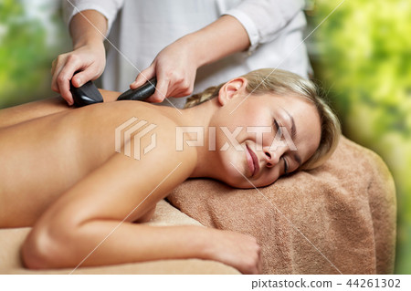 close up of woman having hot stone massage in spa close up of woman having hot stone massage in spa 44261302