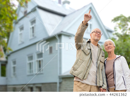 happy senior couple over living house background happy senior couple over living house background 44261362