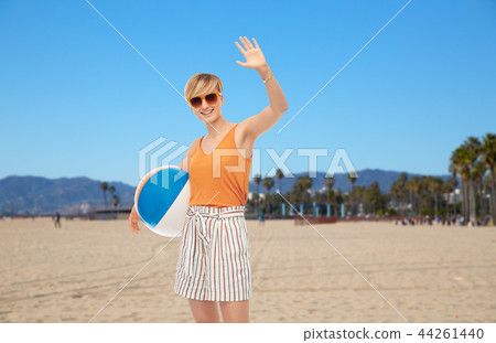 smiling teenage girl with ball over venice beach 44261440