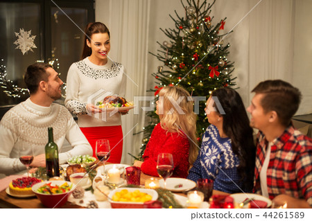 happy friends having christmas dinner at home happy friends having christmas dinner at home 44261589