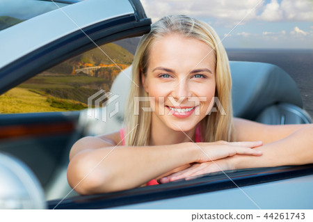 woman in convertible car on big sur coast 44261743