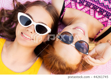 teenage girls in sunglasses on picnic blanket teenage girls in sunglasses on picnic blanket 44261745