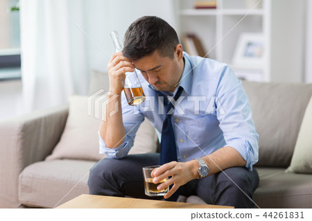 alcoholic with bottle drinking whiskey at home 44261831