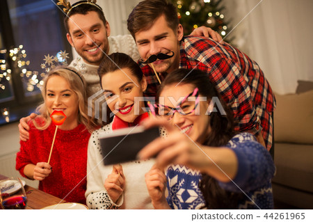 friends taking selfie at christmas dinner 44261965