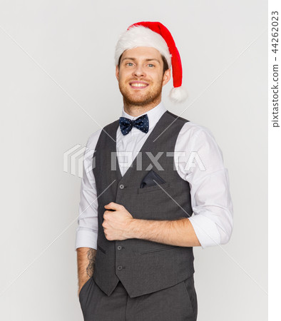 happy man in santa hat and suit at christmas happy man in santa hat and suit at christmas 44262023