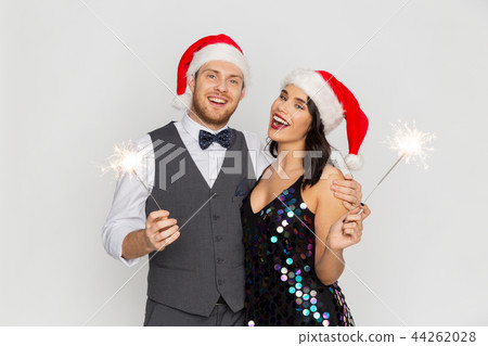 happy couple in santa hats at christmas party happy couple in santa hats at christmas party 44262028