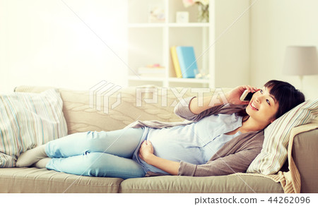 happy pregnant woman calling on smartphone at home 44262096