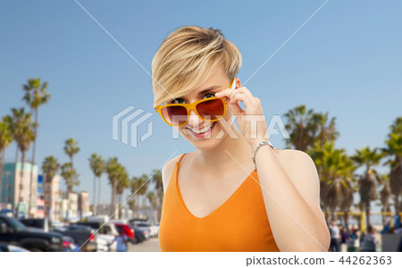 portrait of smiling young woman in sunglasses portrait of smiling young woman in sunglasses 44262363