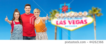 happy friends showing thumbs up at las vegas sign happy friends showing thumbs up at las vegas sign 44262366