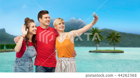 friends taking selfie by smartphone over bora bora friends taking selfie by smartphone over bora bora 44262368