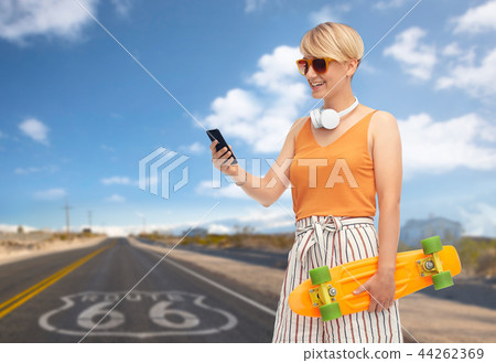 teenage girl with skateboard and smartphone 44262369