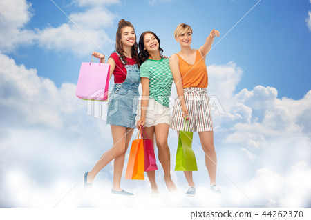 happy female friends with shopping bags happy female friends with shopping bags 44262370