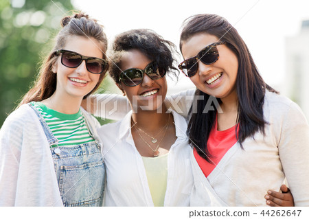 happy young women in sunglasses outdoors happy young women in sunglasses outdoors 44262647