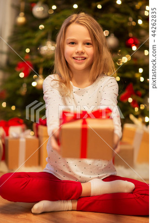 smiling girl with christmas gift at home smiling girl with christmas gift at home 44262835