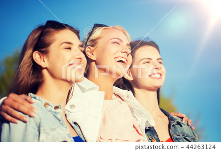 happy women or teenage girls hugging outdoors 44263124