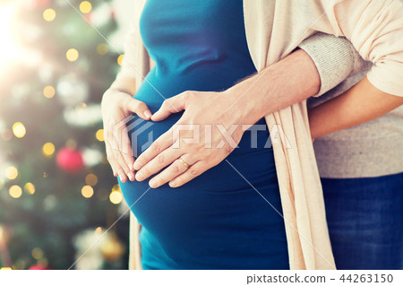close up of man and pregnant woman at christmas close up of man and pregnant woman at christmas 44263150
