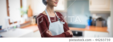 Composite image of thoughtful female chef standing with arms crossed Composite image of thoughtful female chef standing with arms crossed 44263739
