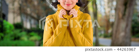Composite image of woman in winter clothing posing against white background 44263967