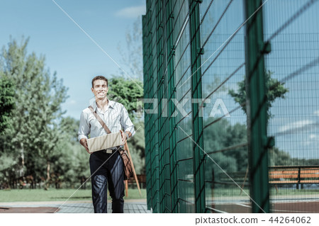 Young male courier offering fast delivery service Young male courier offering fast delivery service 44264062
