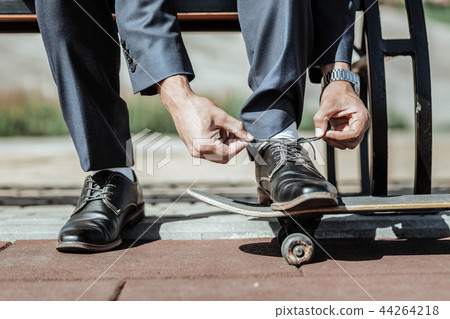 Attractive male hands tying laces on shoes 44264218