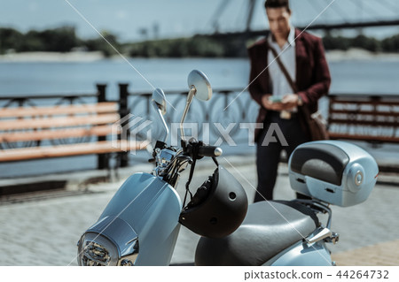 Attractive guy coming to his modern motorbike 44264732