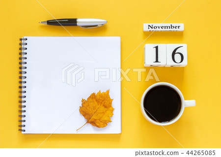 calendar November 16 cup of coffee, notepad with pen and yellow leaf on yellow background calendar November 16 cup of coffee, notepad with pen and yellow leaf on yellow background 44265085