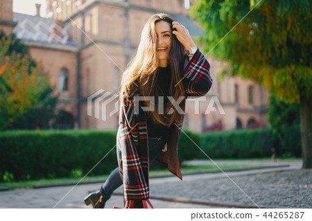 stylish girl walking through the city stylish girl walking through the city 44265287