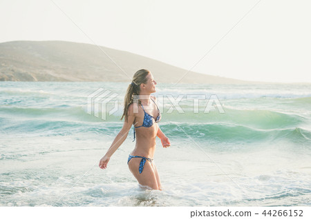 Young woman enjoying warm waters of Mediterranean sea, Greece Young woman enjoying warm waters of Mediterranean sea, Greece 44266152