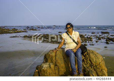 Cute woman relaxing on the tropical beach, Goa Cute woman relaxing on the tropical beach, Goa 44266444