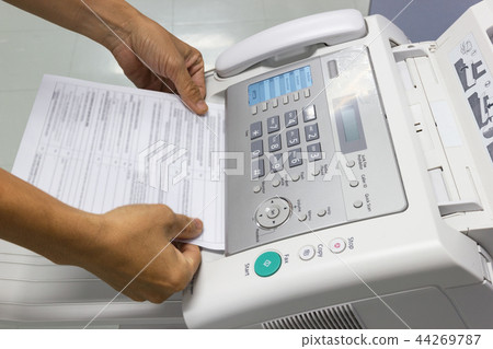 Hand man are using a fax machine in the office 44269787