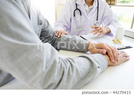 patient listening intently to a male doctor explaining patient s 44270415
