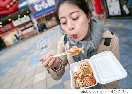 cute woman is blowing octopus balls cute woman is blowing octopus balls 44271252