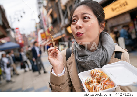 woman is so excited when she ate takoyaki woman is so excited when she ate takoyaki 44271253