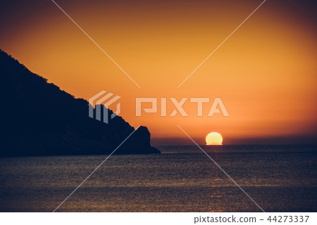 Sunset or sunrise over sea surface Sunset or sunrise over sea surface 44273337